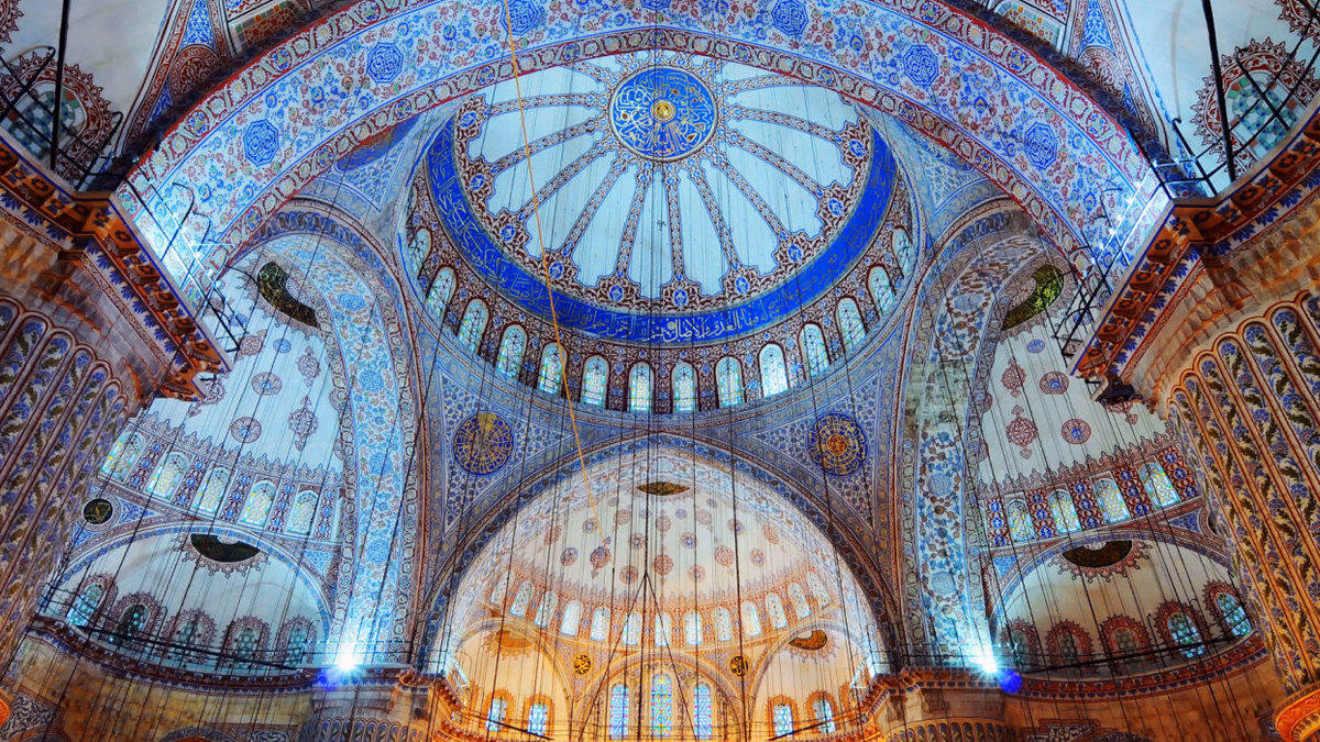 Blue Mosque interior showing Iznik tiles, central dome and stained-glass windows